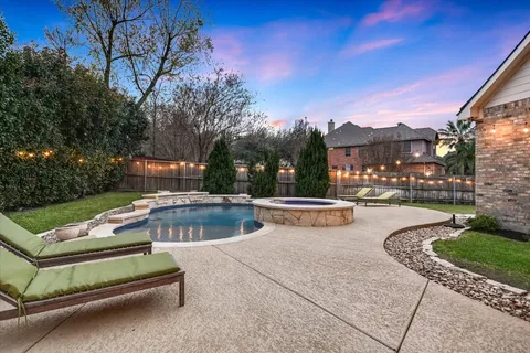a view of swimming pool with outdoor seating and city view