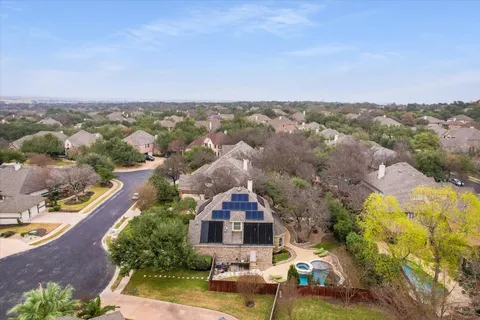 an aerial view of a house with a swimming pool