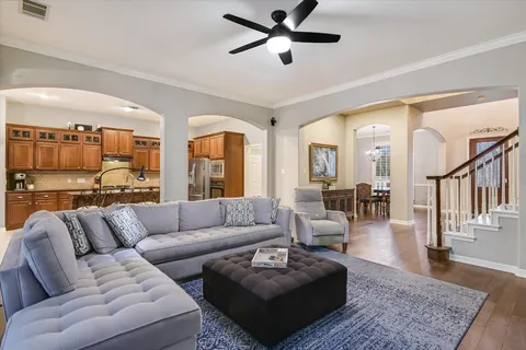 a living room with furniture and a wooden floor