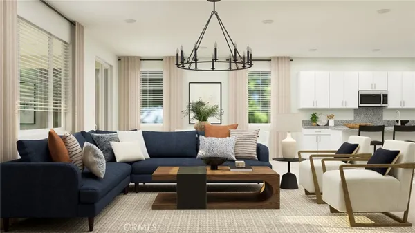 a living room with furniture ceiling fan and a window