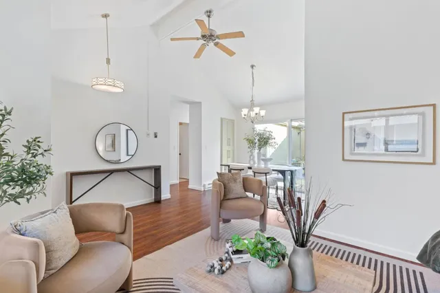 a living room with furniture a window and a chandelier