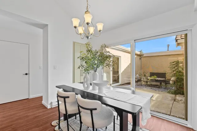 a view of a dining room with furniture wooden floor and chandelier