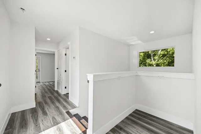 a view of small space with wooden floor and a window