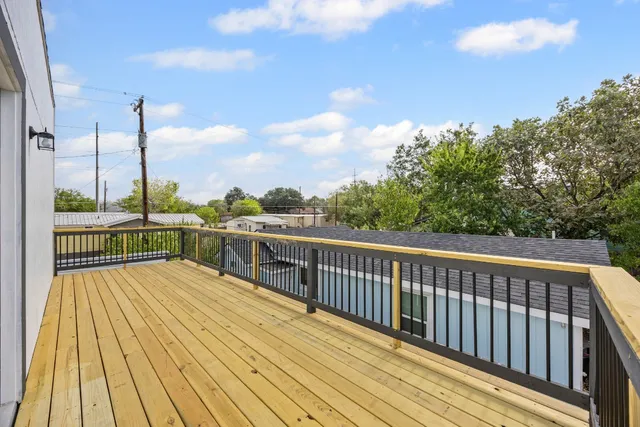 a view of balcony with wooden floor and fence