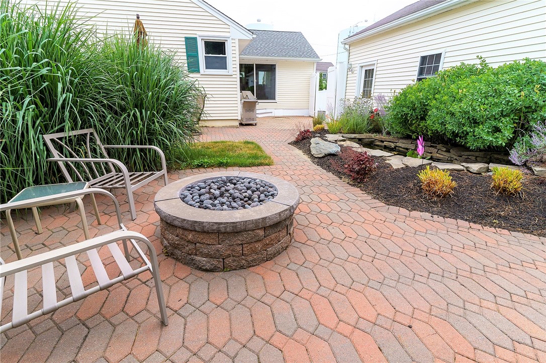 56 Pine Tree Road Portsmouth, RI 02871 - Photo 20 of 27 brick patio with gas firepit and koi pond