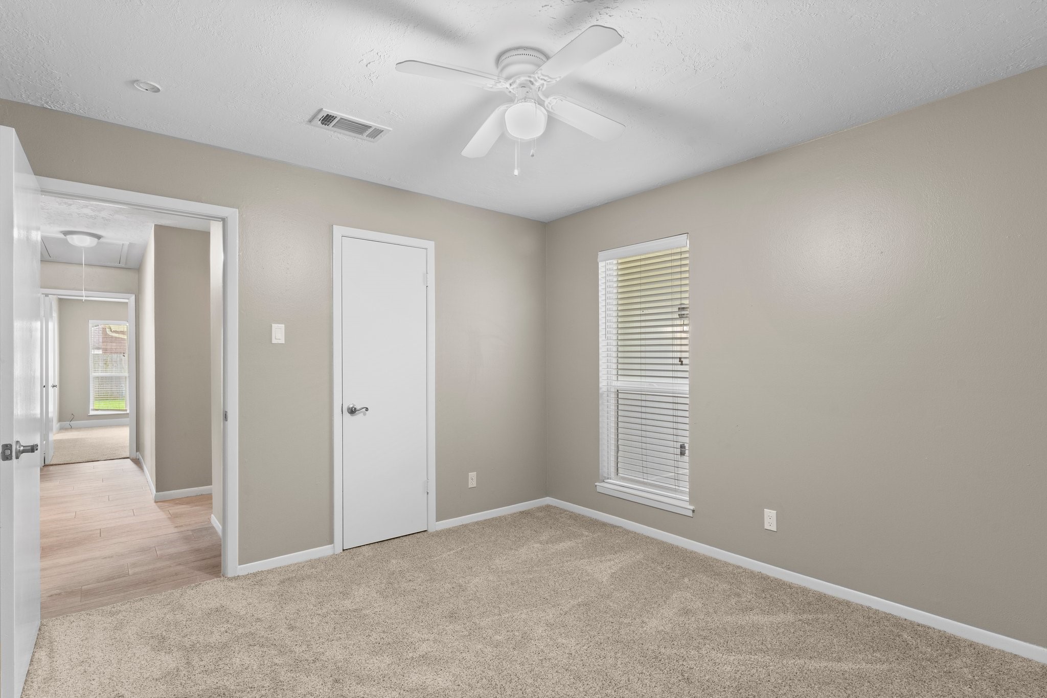 27234 Wells Lane Conroe, TX 77385 - Photo 12 of 15 an empty room with windows and fan