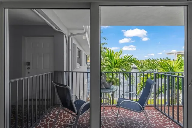 a balcony with table and chairs