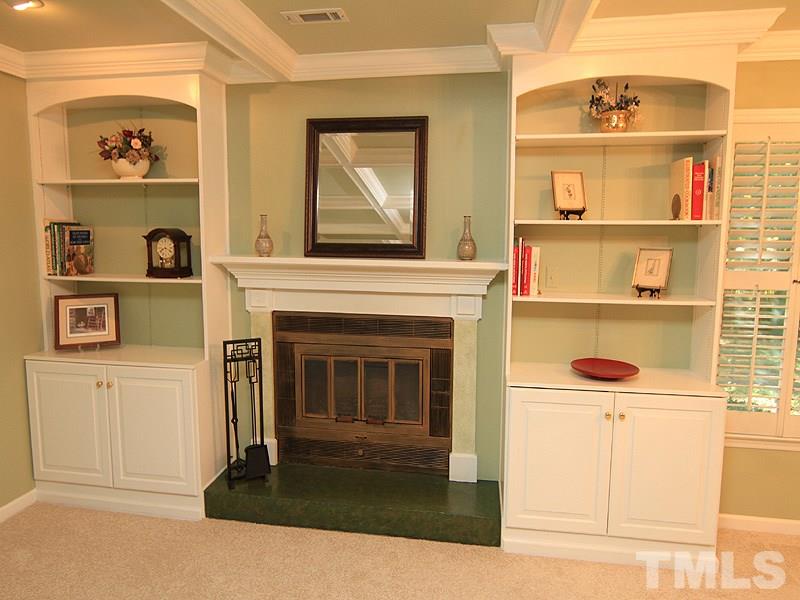 1530 Edgeside Court Raleigh, NC 27609 - Photo 2 of 20 a living room with a fireplace and a wooden floor