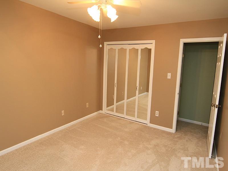 1530 Edgeside Court Raleigh, NC 27609 - Photo 13 of 20 an empty room with chandelier fan