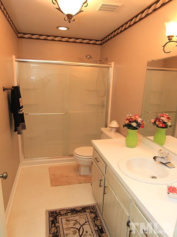 1530 Edgeside Court Raleigh, NC 27609 - Photo 14 of 20 a bathroom with a sink a toilet and shower