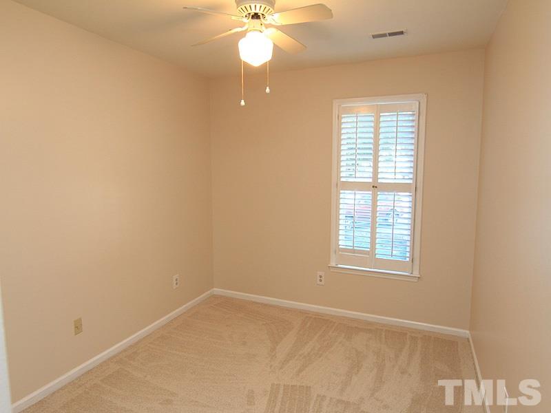 1530 Edgeside Court Raleigh, NC 27609 - Photo 15 of 20 an empty room with windows and fan