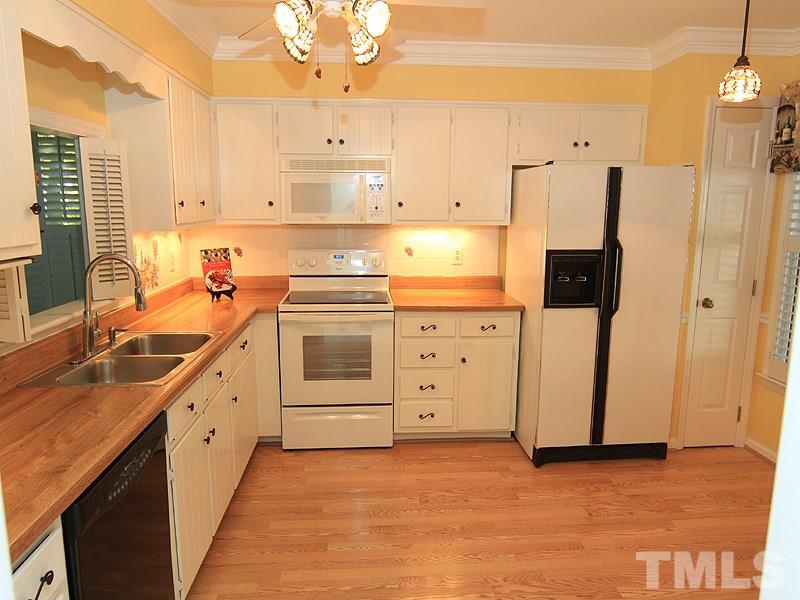 1530 Edgeside Court Raleigh, NC 27609 - Photo 4 of 20 a kitchen with granite countertop a sink stainless steel appliances and cabinets