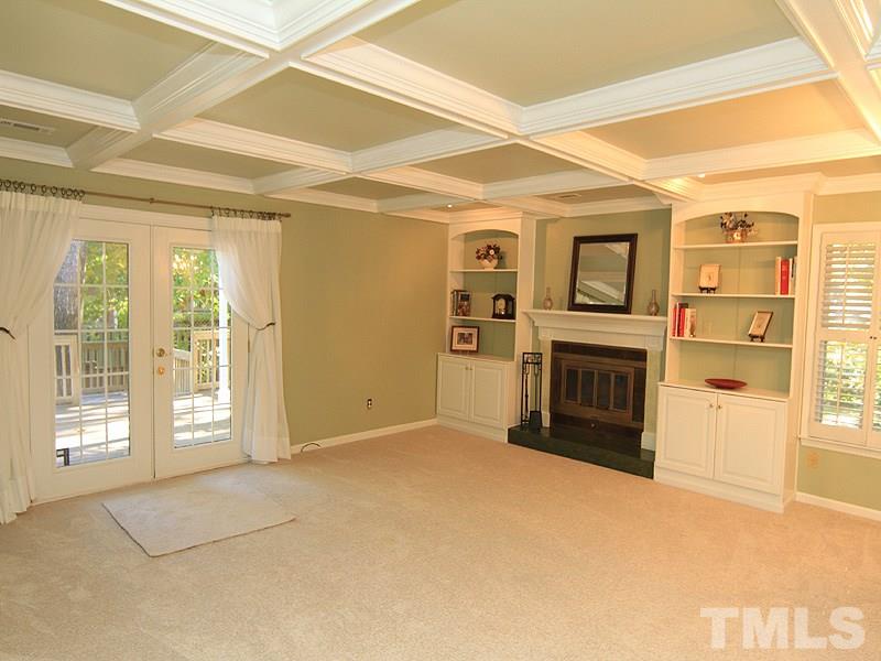 1530 Edgeside Court Raleigh, NC 27609 - Photo 8 of 20 a view of an empty room with a fireplace and a window