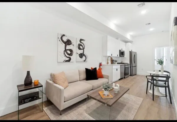 a living room with furniture and wooden floor