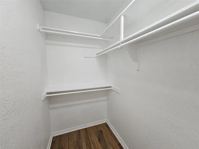 a view of walk in closet with empty racks