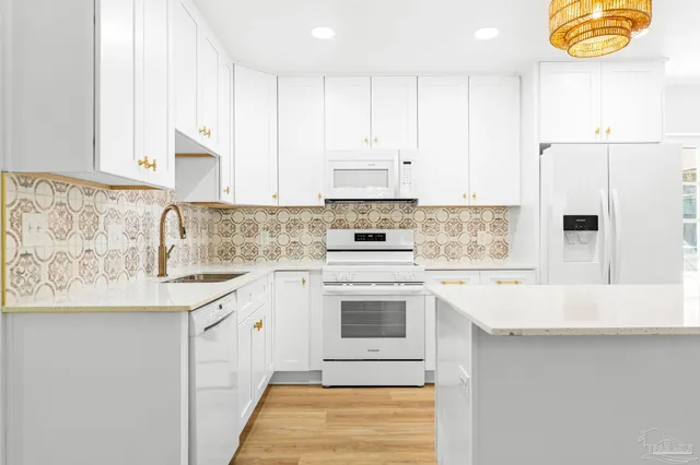 a view of a kitchen with wooden floor and a chandelier