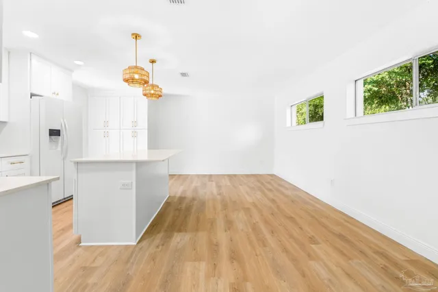 a kitchen with cabinets appliances a sink and a counter top