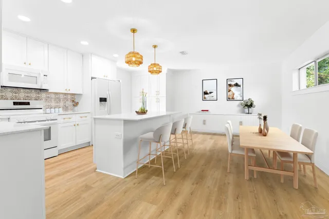 a view of a livingroom with wooden floor and a ceiling fan
