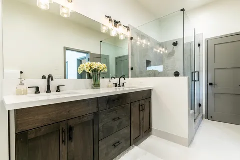 a bathroom with a double vanity sink mirror and double
