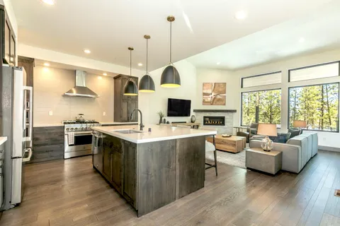 a large kitchen with stainless steel appliances granite countertop a stove and cabinets