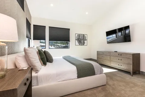 a bedroom with a bed and a flat screen tv