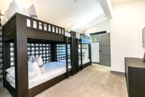 a bedroom with a bed and a large window