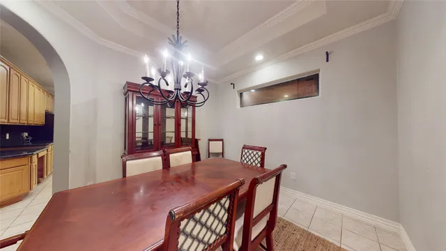 a view of a dining room with furniture and chandelier