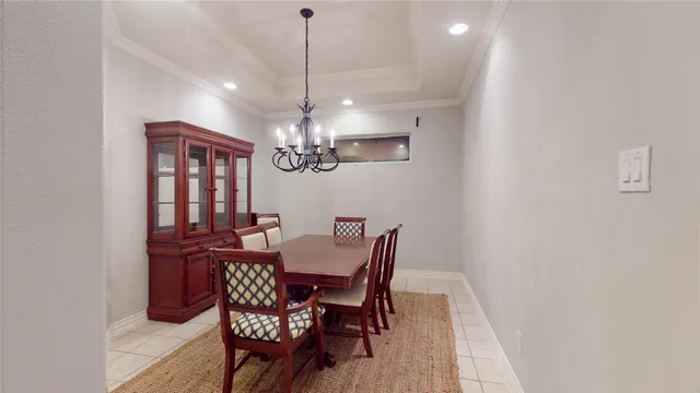 a view of a dining room with furniture a chandelier and wooden floor