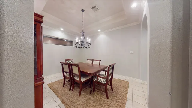 a view of a dining room with a table and chairs