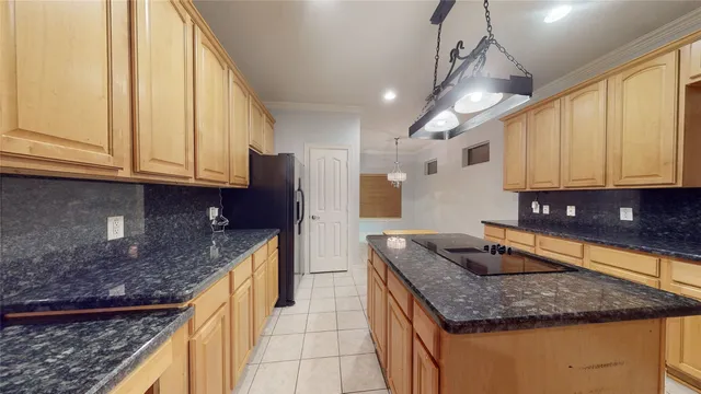 a kitchen with stainless steel appliances granite countertop a sink a stove and a microwave