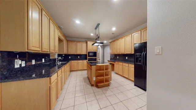 a large white kitchen with a large window and stainless steel appliances