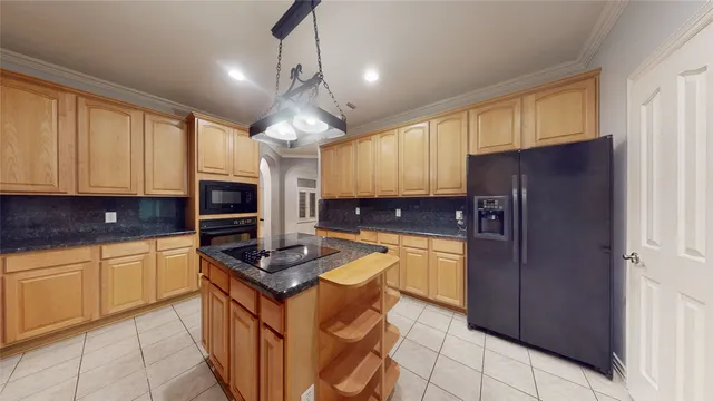 a kitchen with stainless steel appliances granite countertop a refrigerator stove top oven and sink