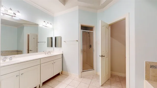 a bathroom with a double vanity sink and mirror