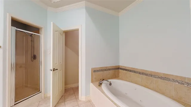 a white bath tub sitting next to a shower