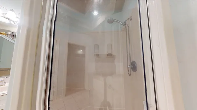 a bathroom with a glass shower door