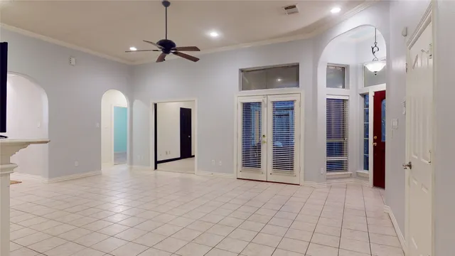a view of a hallway with wooden floor and a chandelier