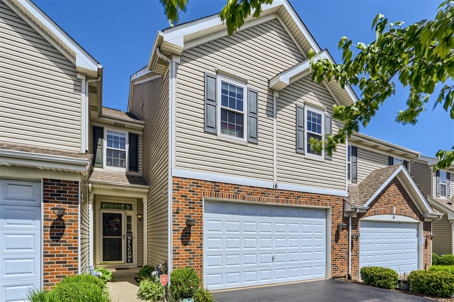 16 Blue Stem Court Streamwood, IL 60107 - Photo 1 of 27 a view of a house with a small deck and a tree