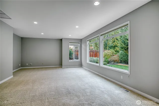a view of a big room with windows and yard