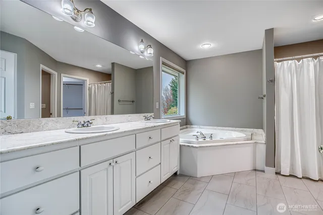 a bathroom with a double vanity sink a mirror and a