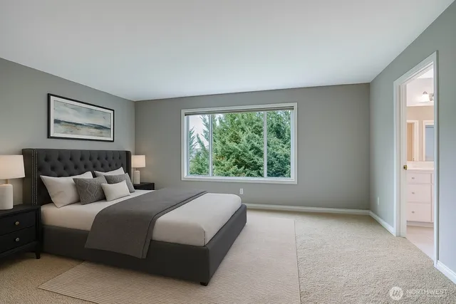 a bedroom with a large bed and a large window