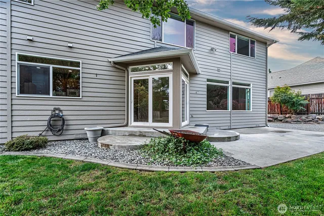 a front view of a house with a yard and potted plants