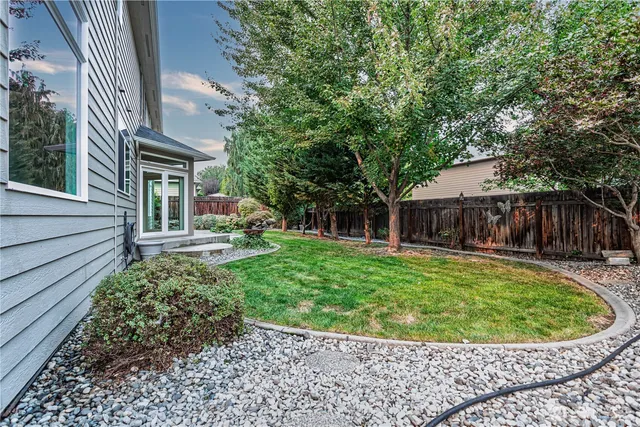 a view of a house with a backyard and sitting area