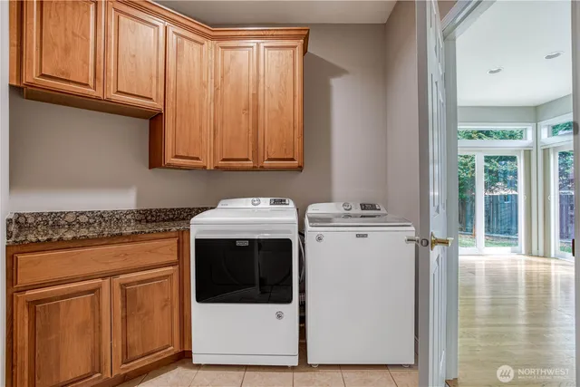 a utility room with sink dryer and washer