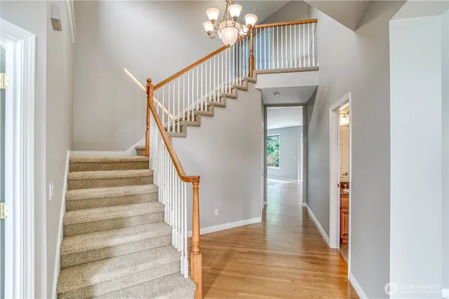 a view of entryway and hall with wooden floor