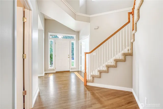 a view of an entryway with wooden floor