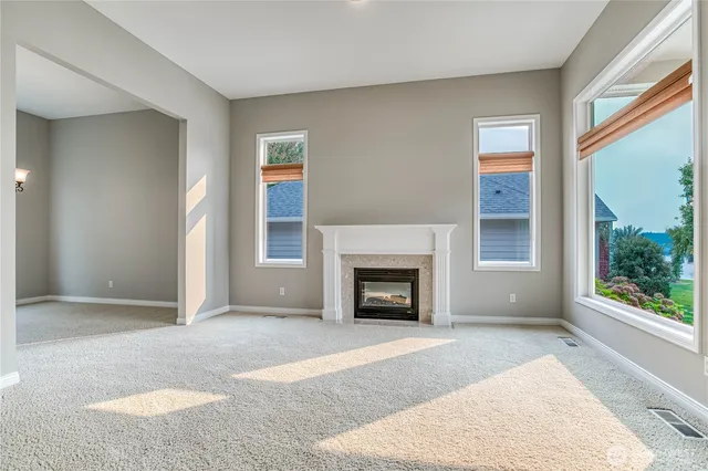 an empty room with furniture and a fireplace