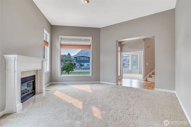a view of empty room with furniture and a fireplace