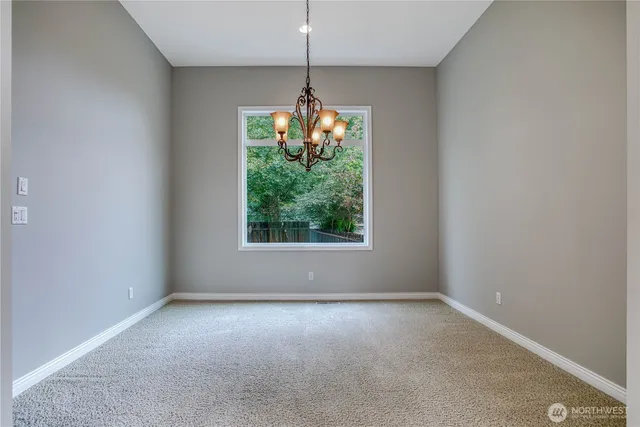 an empty room with windows and outdoor view