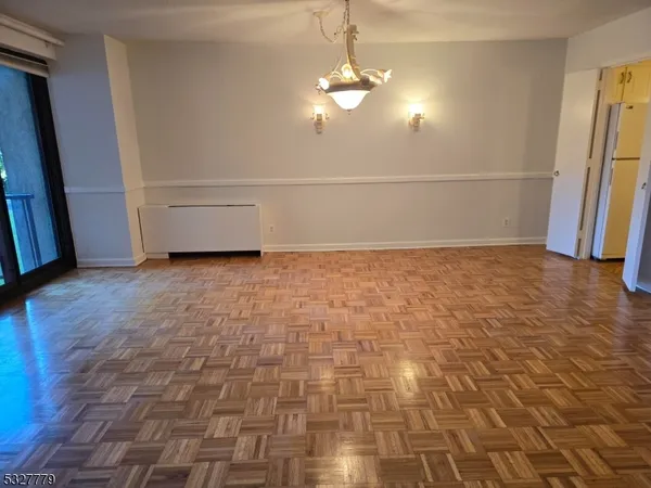 a view of a livingroom with an empty space and a stove top oven