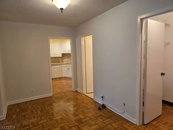 a view of a room with a empty space and a window